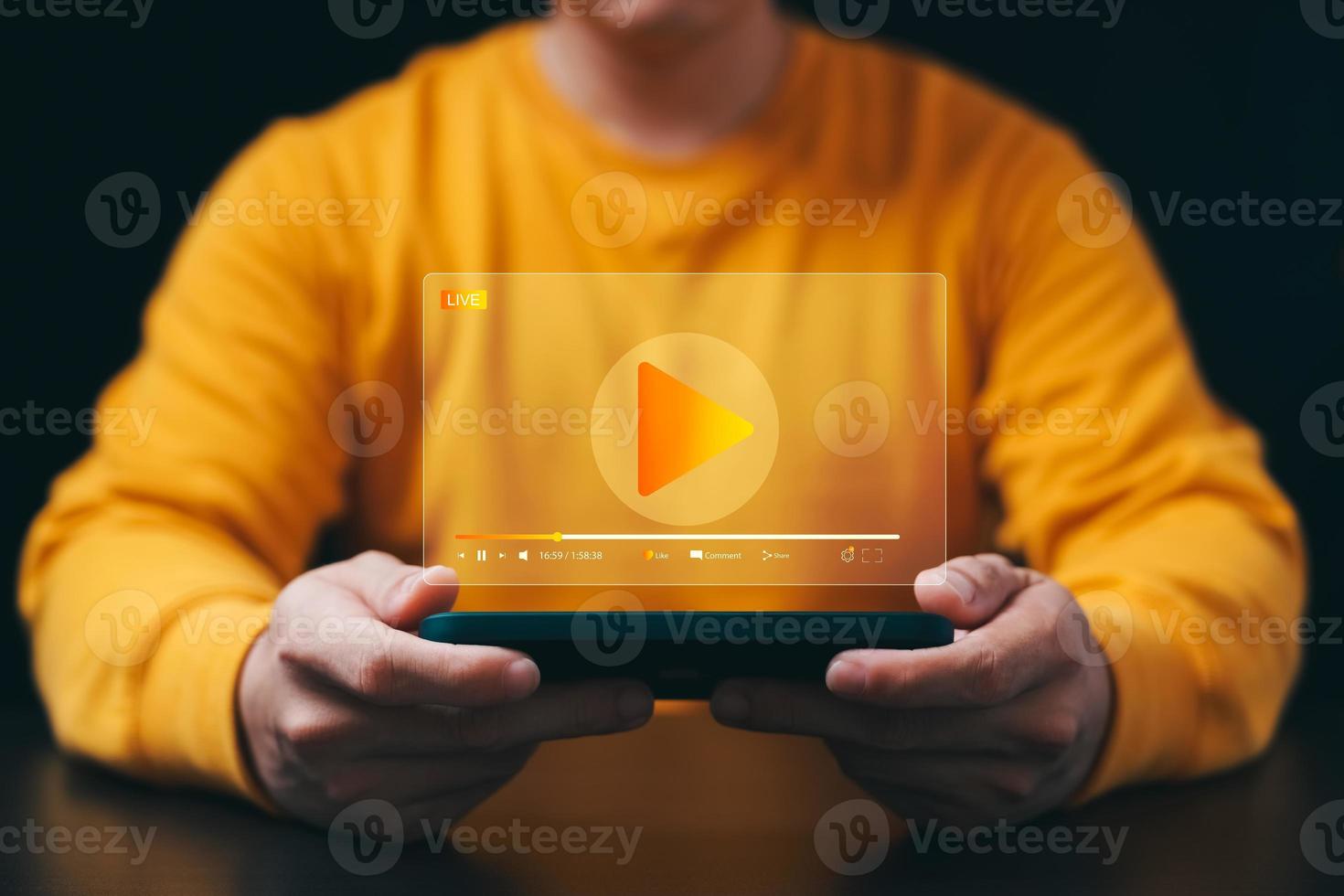 Online movie streaming with smartphone. Young man watching a movie on a mobile phone with an imaginary video player service. photo