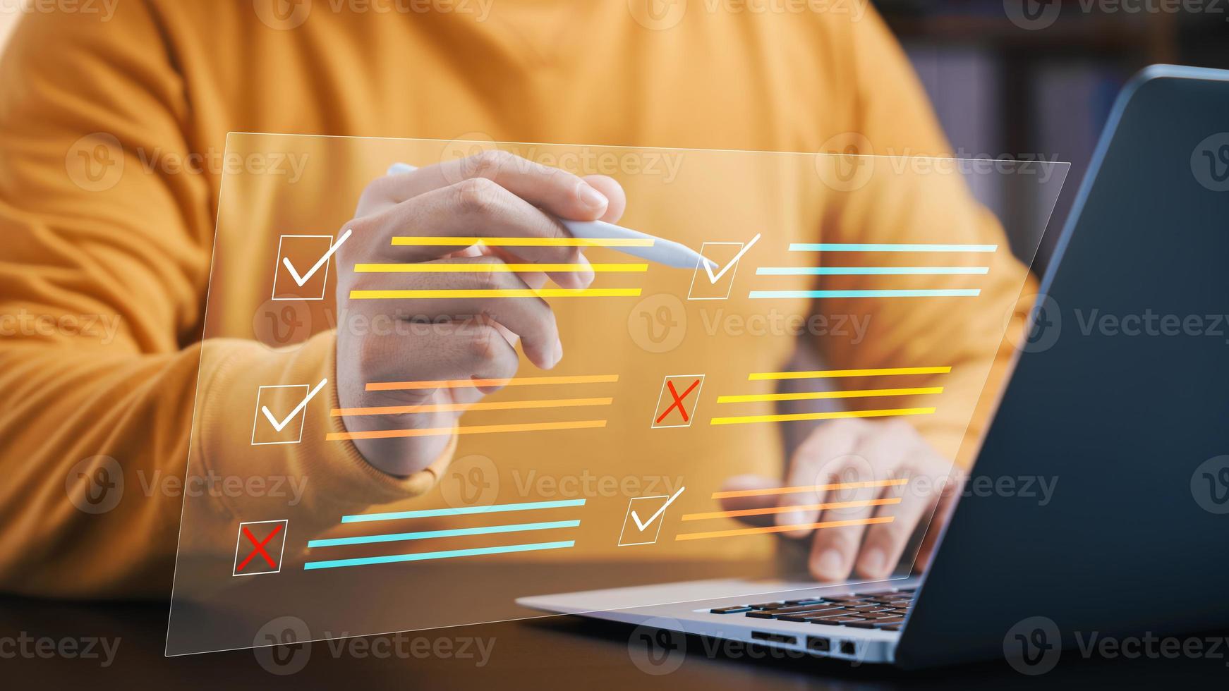 Businessman using laptop to do online checklist survey, doing assessment online survey answer test questions Digital form. photo