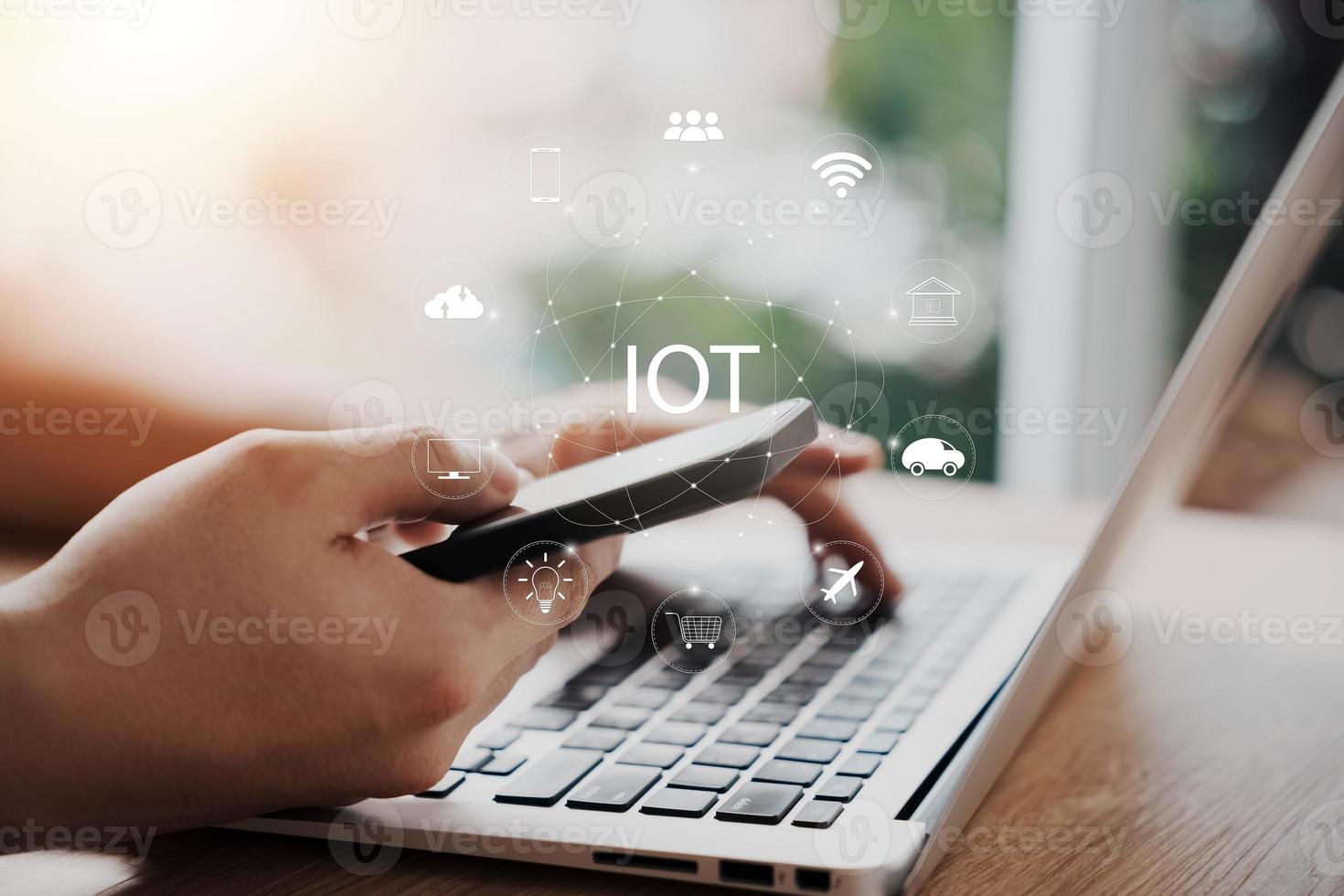 Business AI and IoT concept. Businessman working on laptop computer for artificial intelligence polygonal brain with icons of future Internet of Things smart city. photo