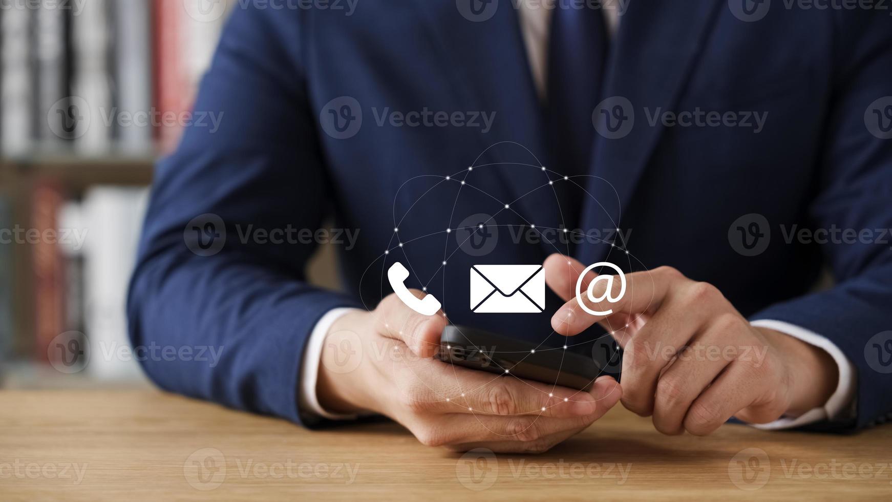 Hand of Businessman holding mobile smartphone. Contact Us, customer support concept. photo