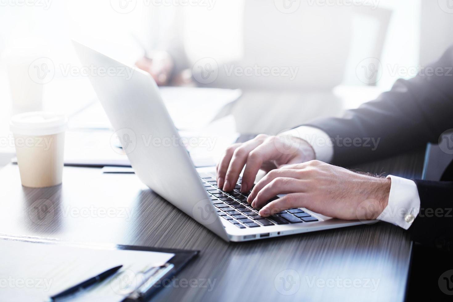 Man working on a laptop. Concept of internet sharing and interconnection photo