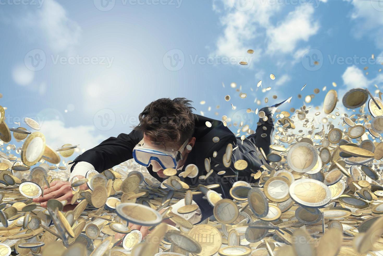 Businessman swims in a pool of money photo