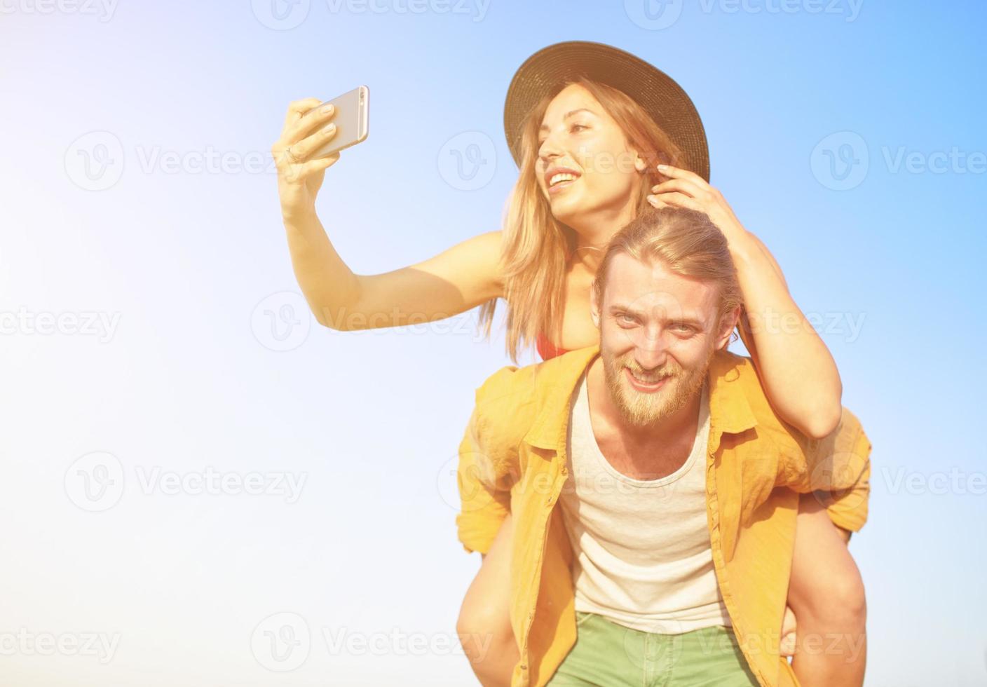 Happy group of friend makes a selfie with a mobile phone. photo
