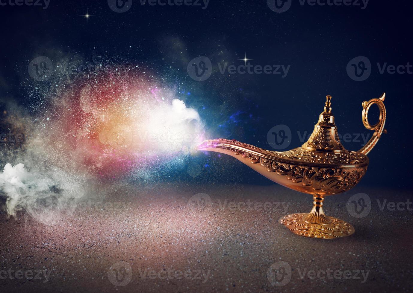 Smoke exists from magic aladdin genie lamp in a desert photo