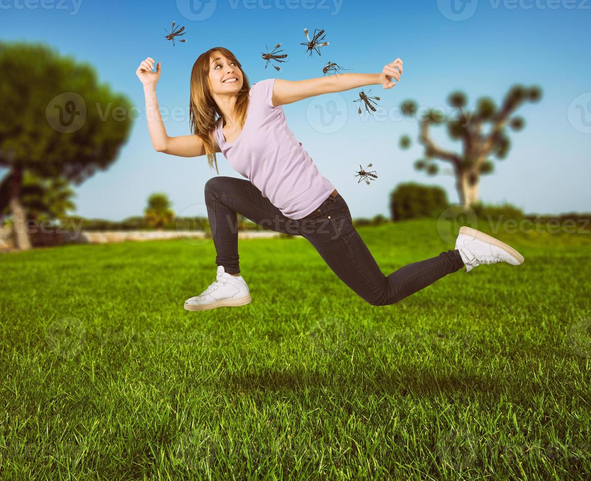 Woman defends herself from the attack of mosquitoes running fast photo