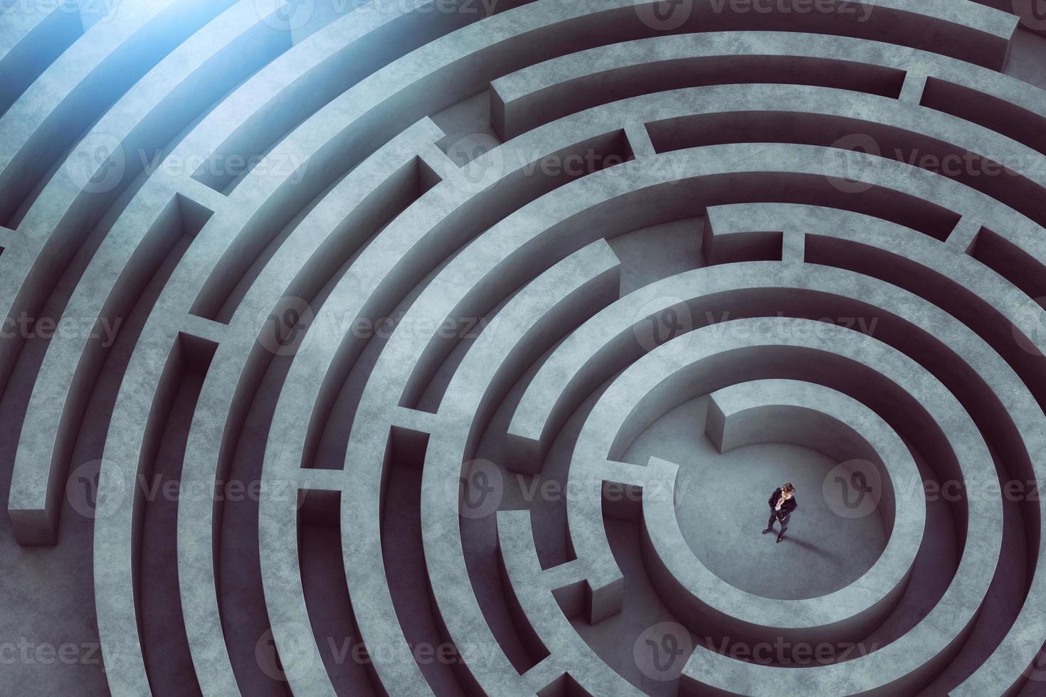 Confused businessman thinks how to find the right way to exit from a big maze photo