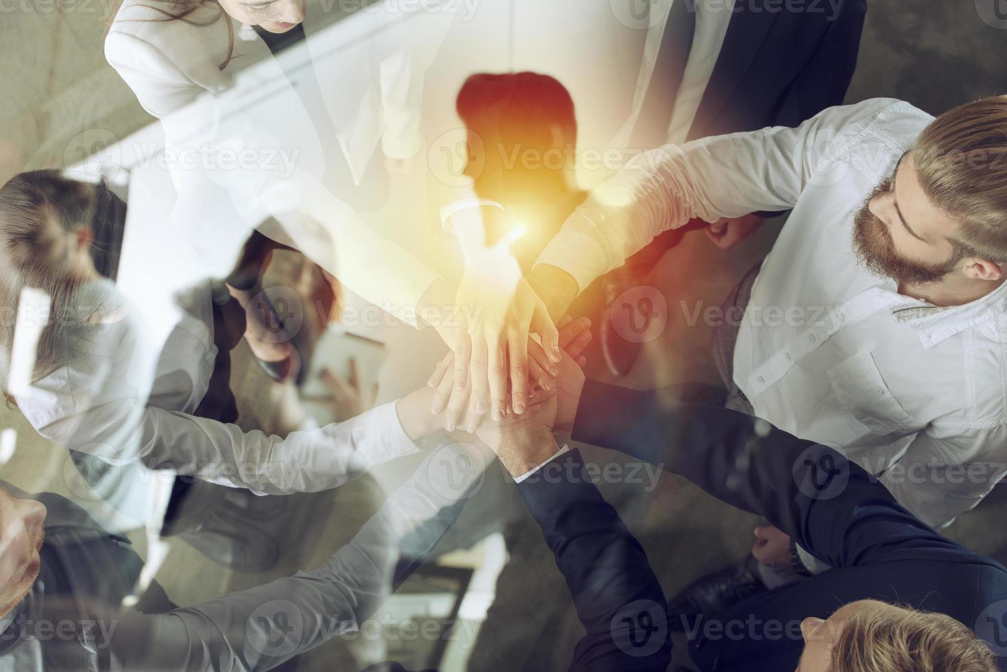Business people putting their hands together. Concept of startup, integration, teamwork and partnership. Double exposure. photo