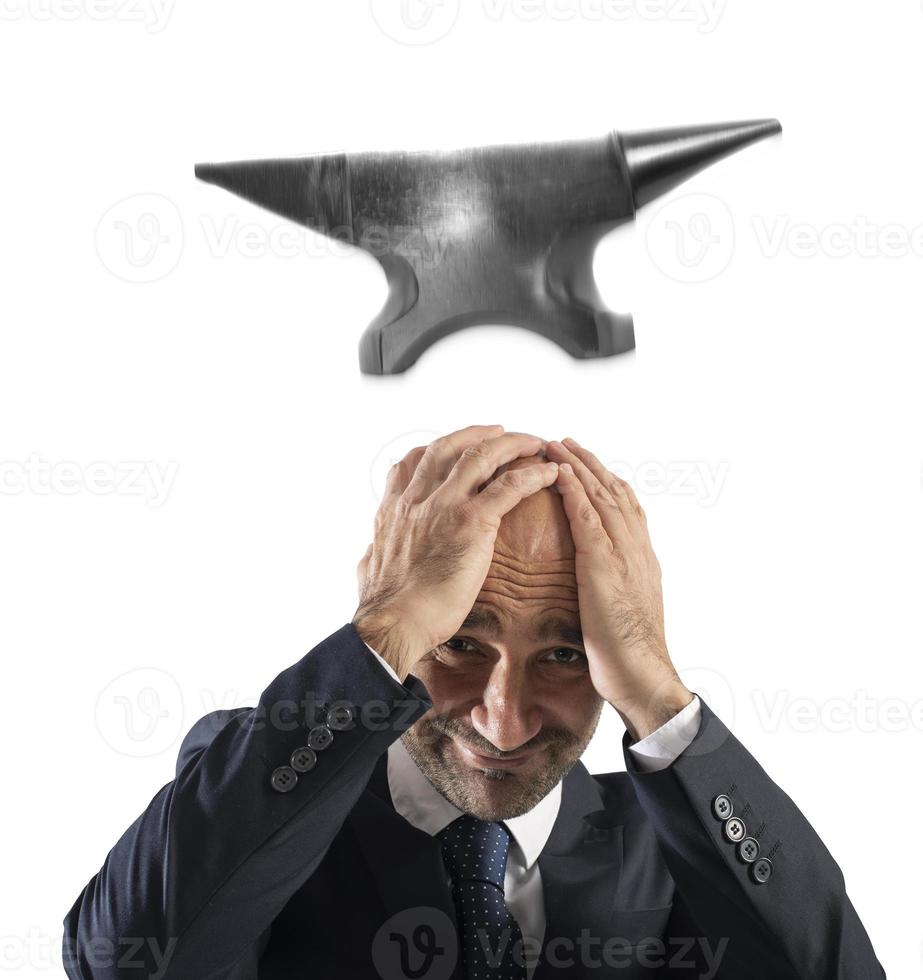 Difficult career in business with falling anvil photo