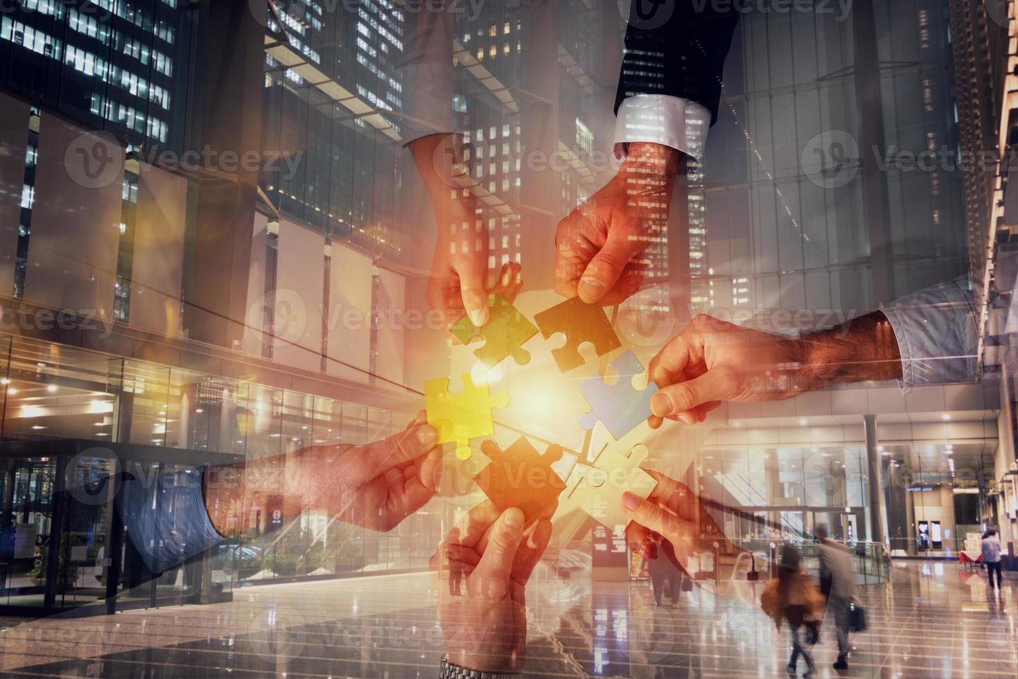 Teamwork of partners connect puzzle pieces as integration and startup photo