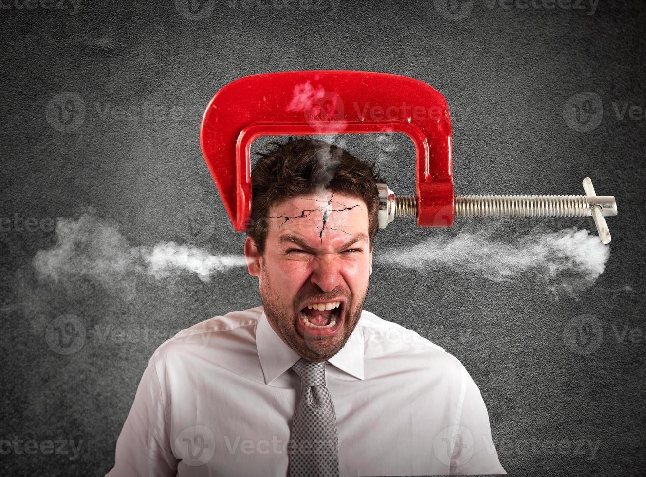 Businessman with a vise on his head. concept of headache photo