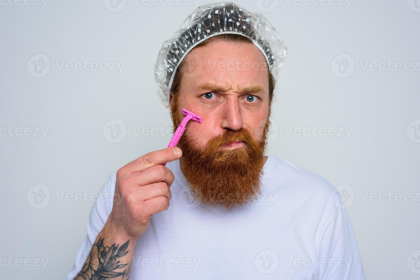 Man adjust the beard with a razor blade photo