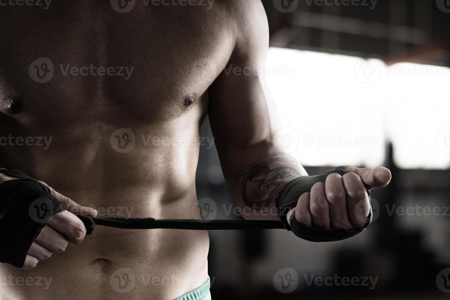 Boxer puts the tapes to his hands photo