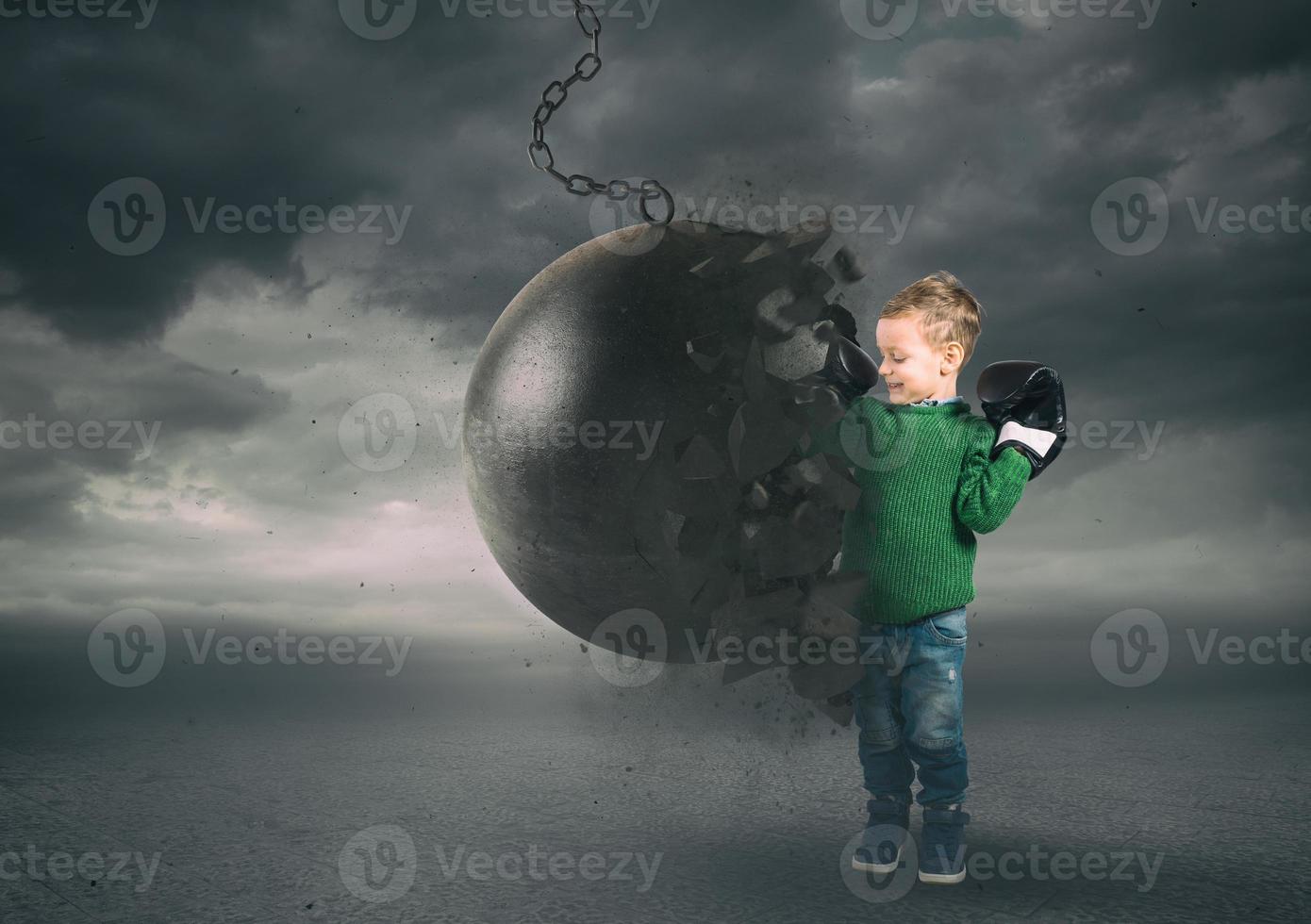 Power and determination of a child against a wrecking ball photo