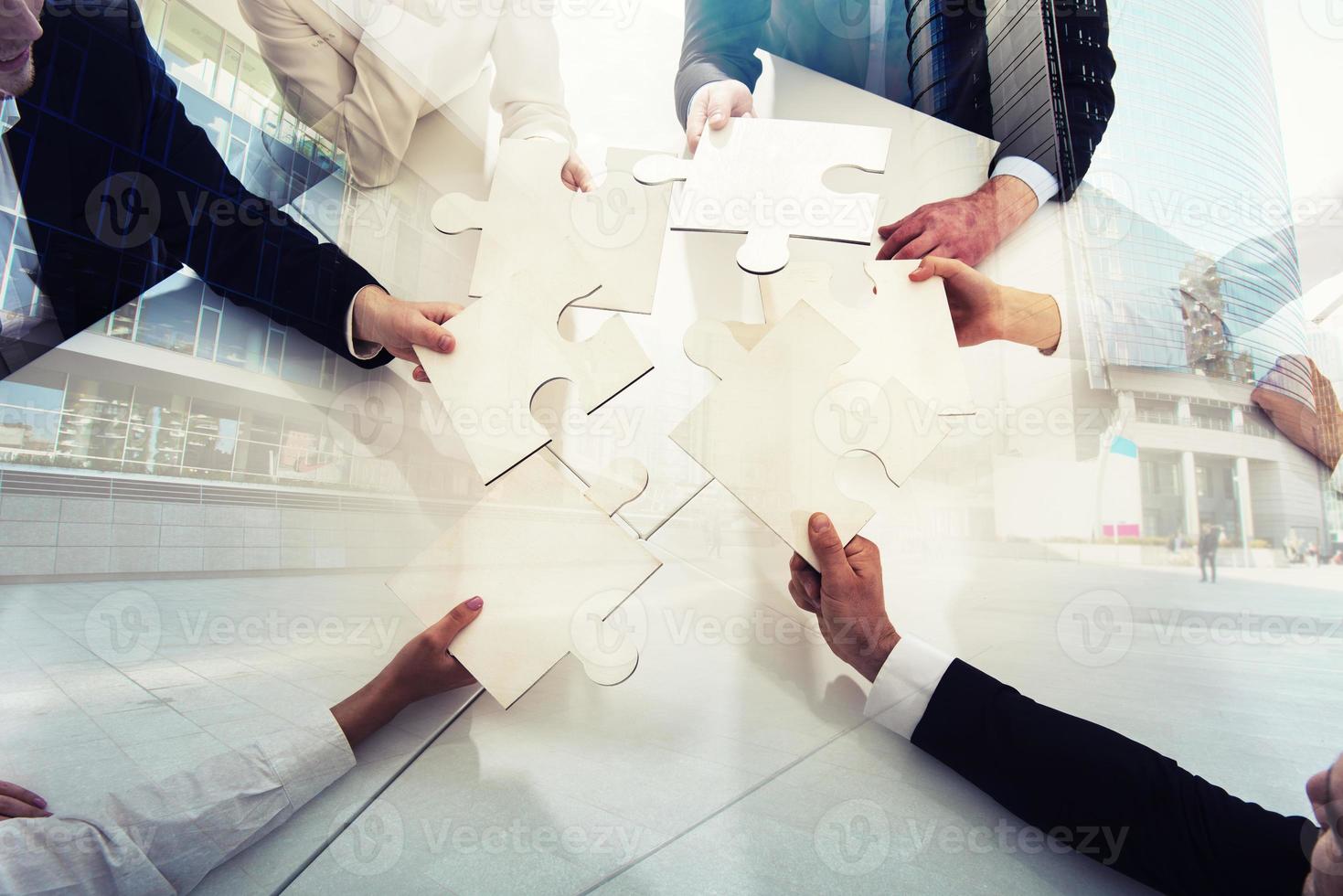 Teamwork of partners. Concept of integration and startup with puzzle pieces. double exposure photo