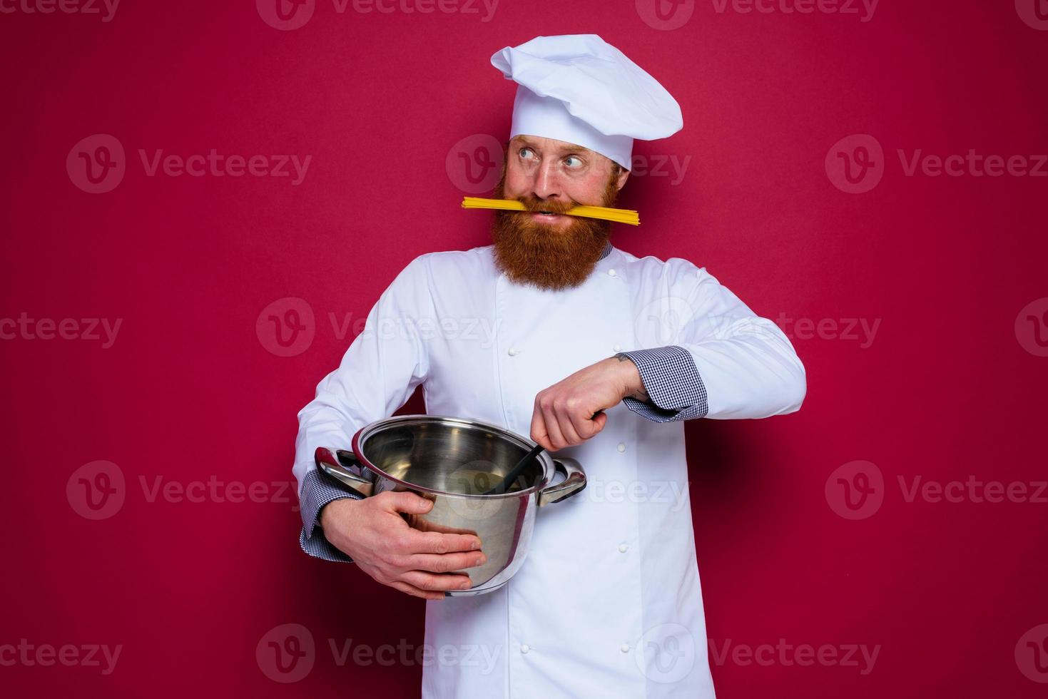 happy chef with beard and red apron is ready to cook photo