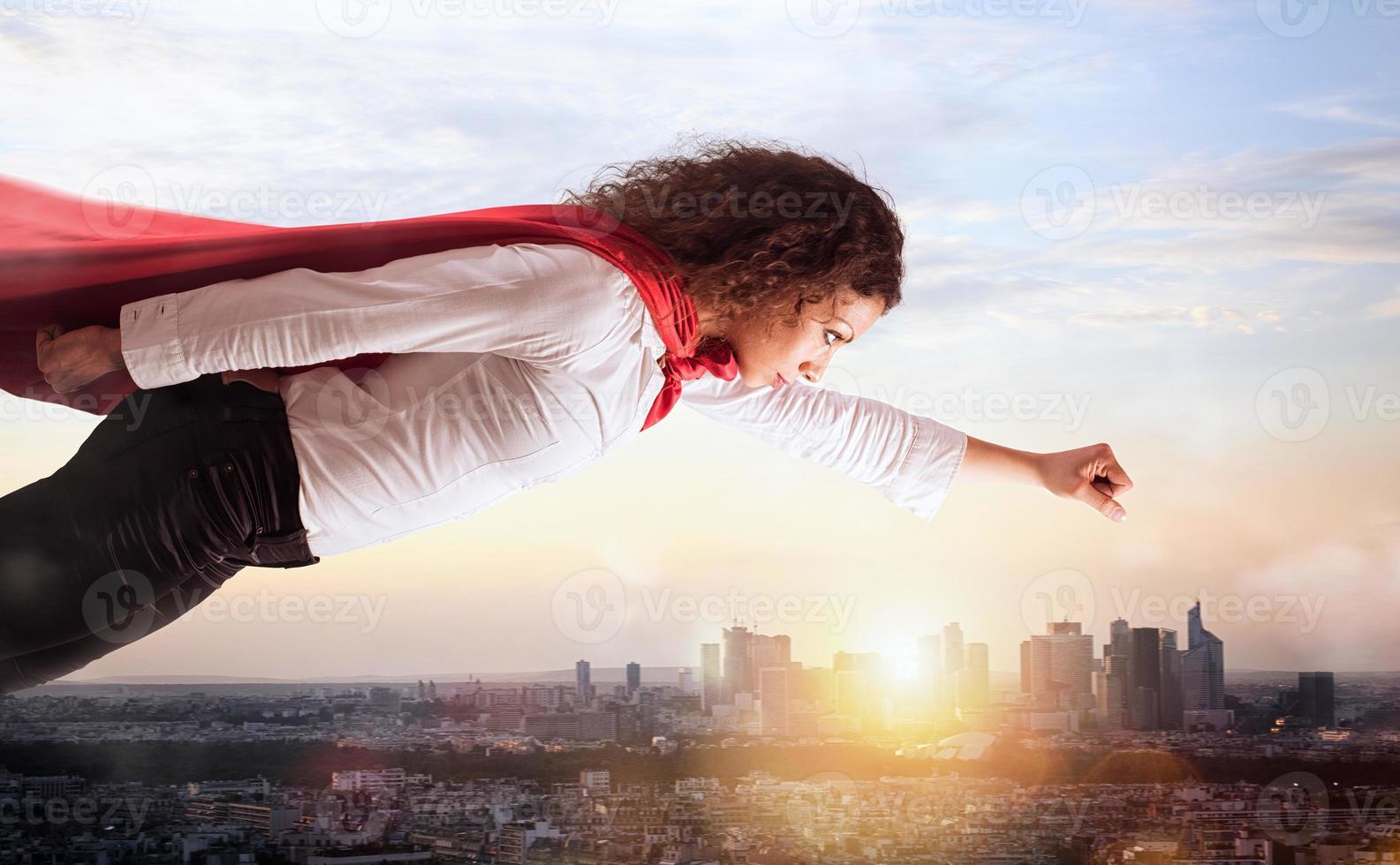 Woman acts like a superhero flying over the city photo