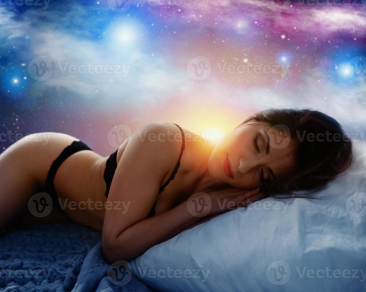 woman sleeps in a cozy bed during the night with space background. Concept of relax and rest. photo