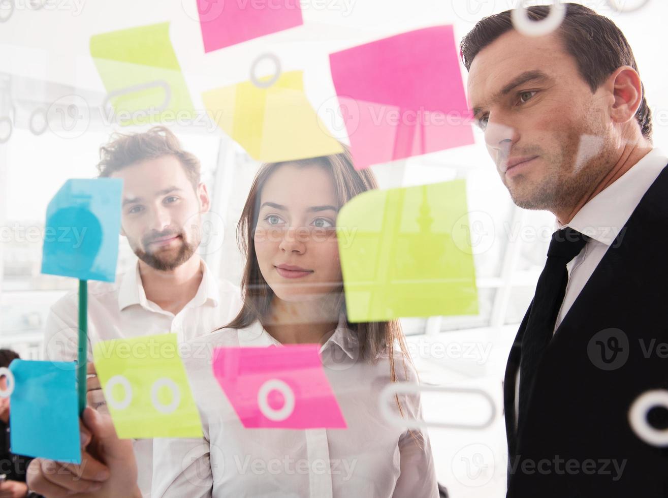 Businessmen that work together in office. Concept of teamwork and partnership photo