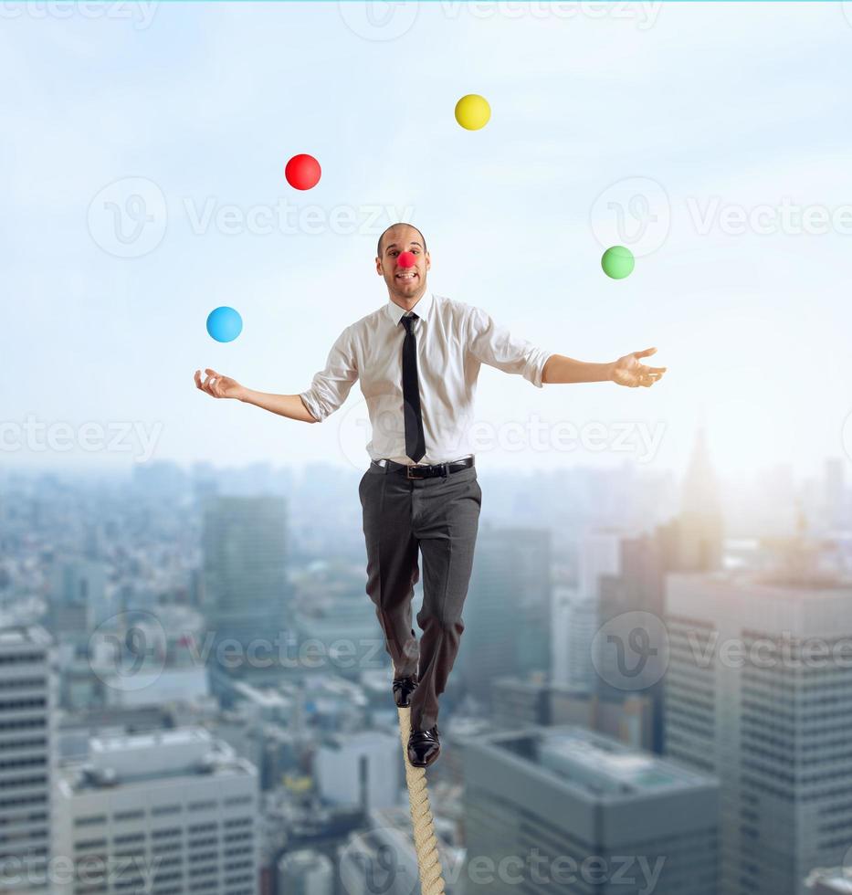 Worry man in balance walking on a rope overand acts like a juggler photo