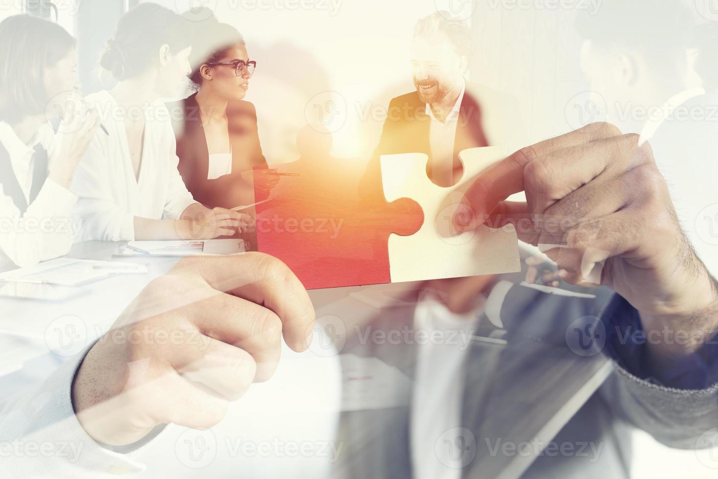 Teamwork of partners. Concept of integration and startup with puzzle pieces. double exposure photo