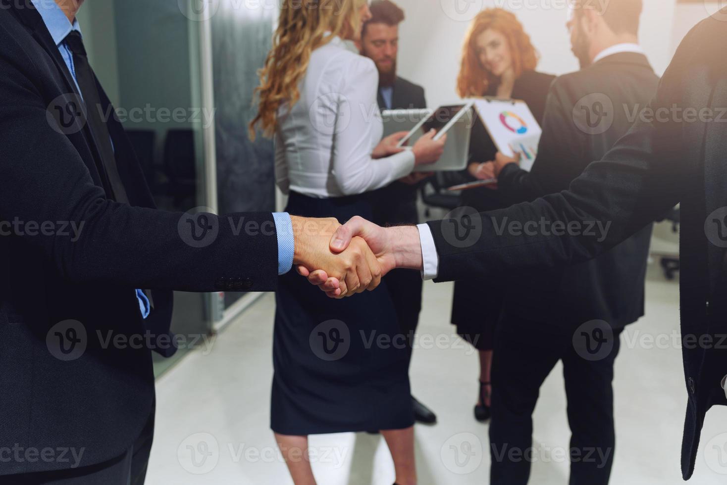 Handshaking of business person in office as teamwork and partnership photo