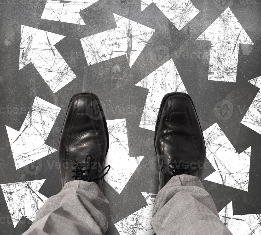 Undecided businessman with arrows as choices photo