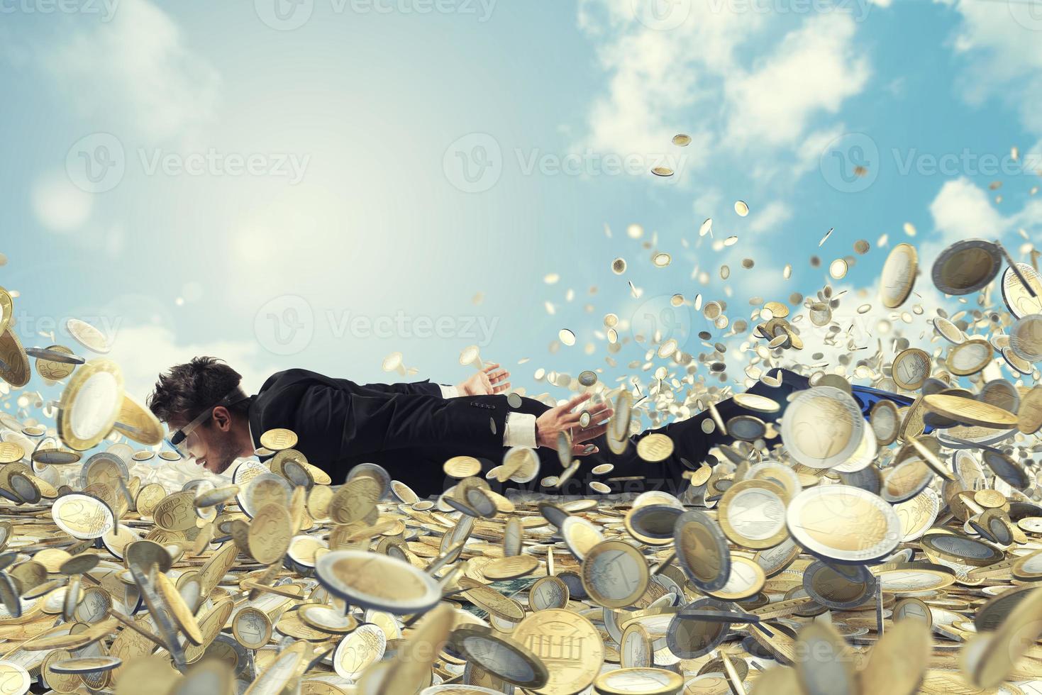 Businessman swims in a sea of money photo