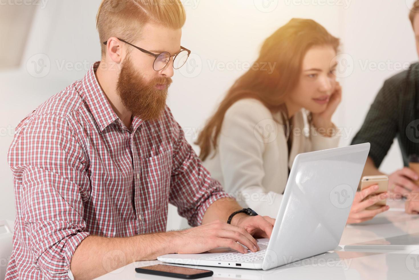 Businessman in office connected on internet network with laptop photo