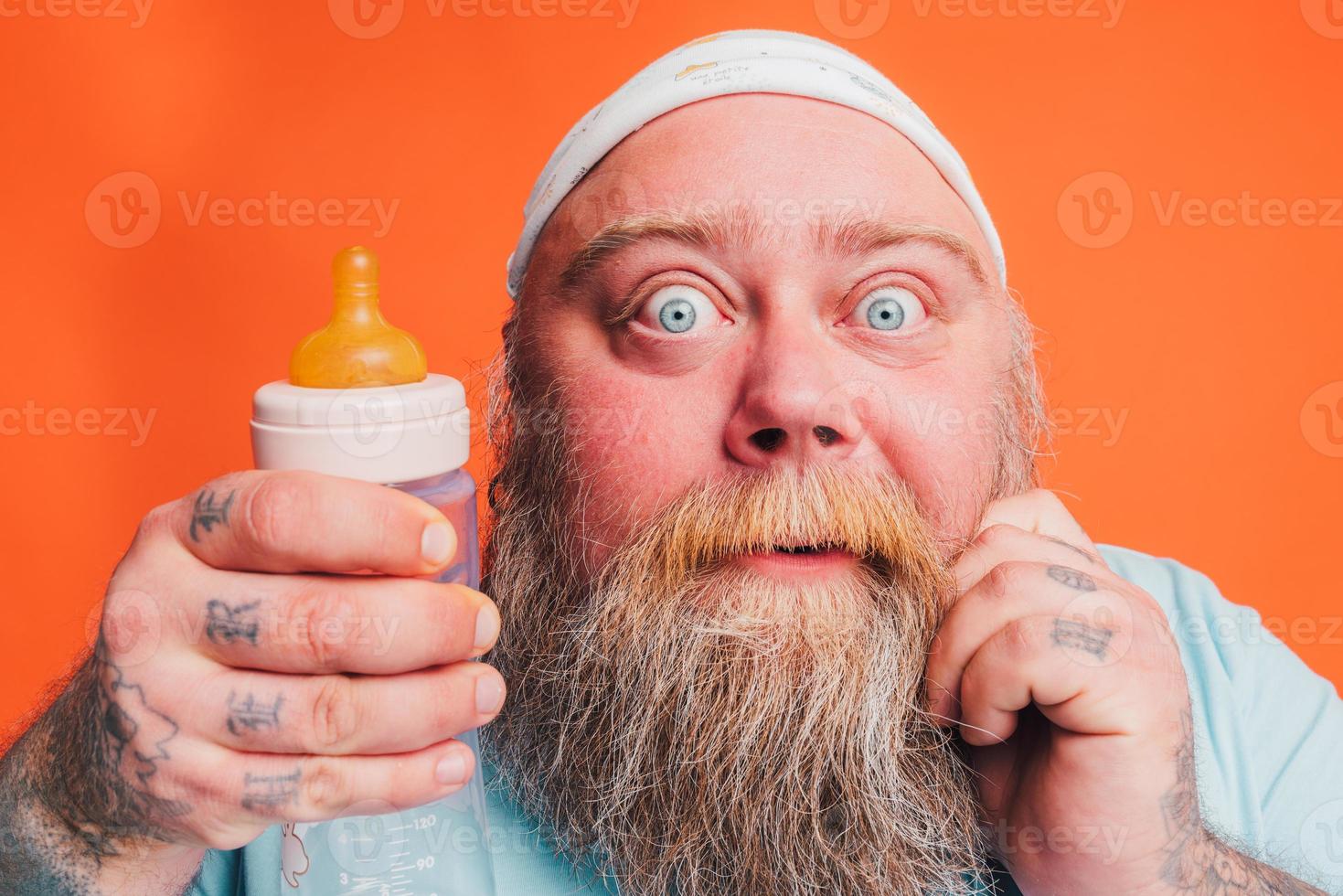Funny man with wig act like a baby and is afraid for something photo