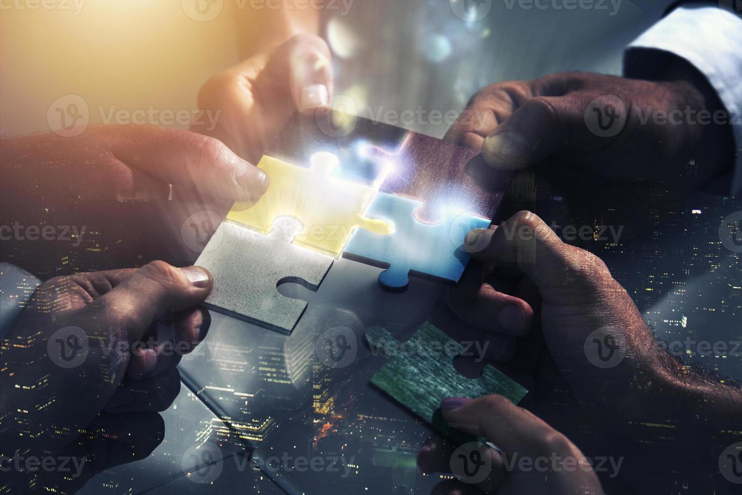 Businessmen working together to build a puzzle. Concept of teamwork, partnership, integration and startup. photo