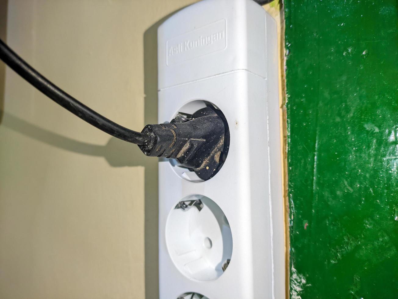 a white socket with a plug attached photo