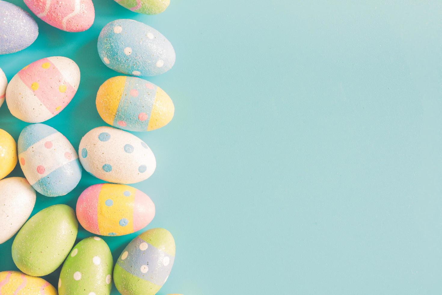 Coloeful easter eggs on pastel color background with space. photo