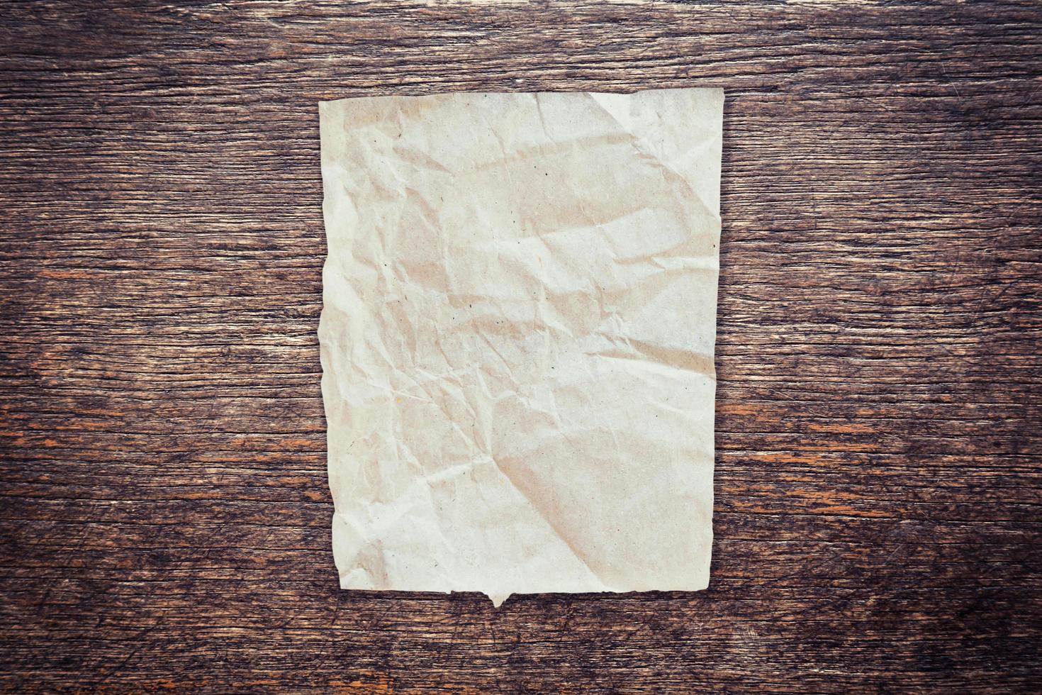 crumpled paper on wood texture and background with copy space. photo