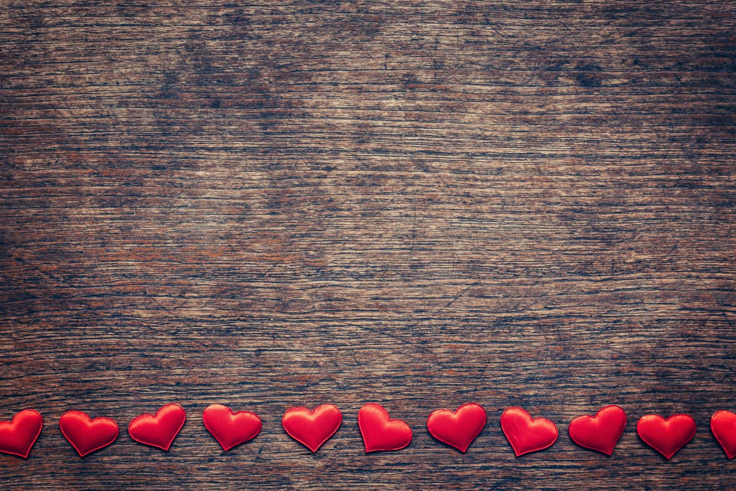 Red heart on wood background with space for Valentine Day. photo