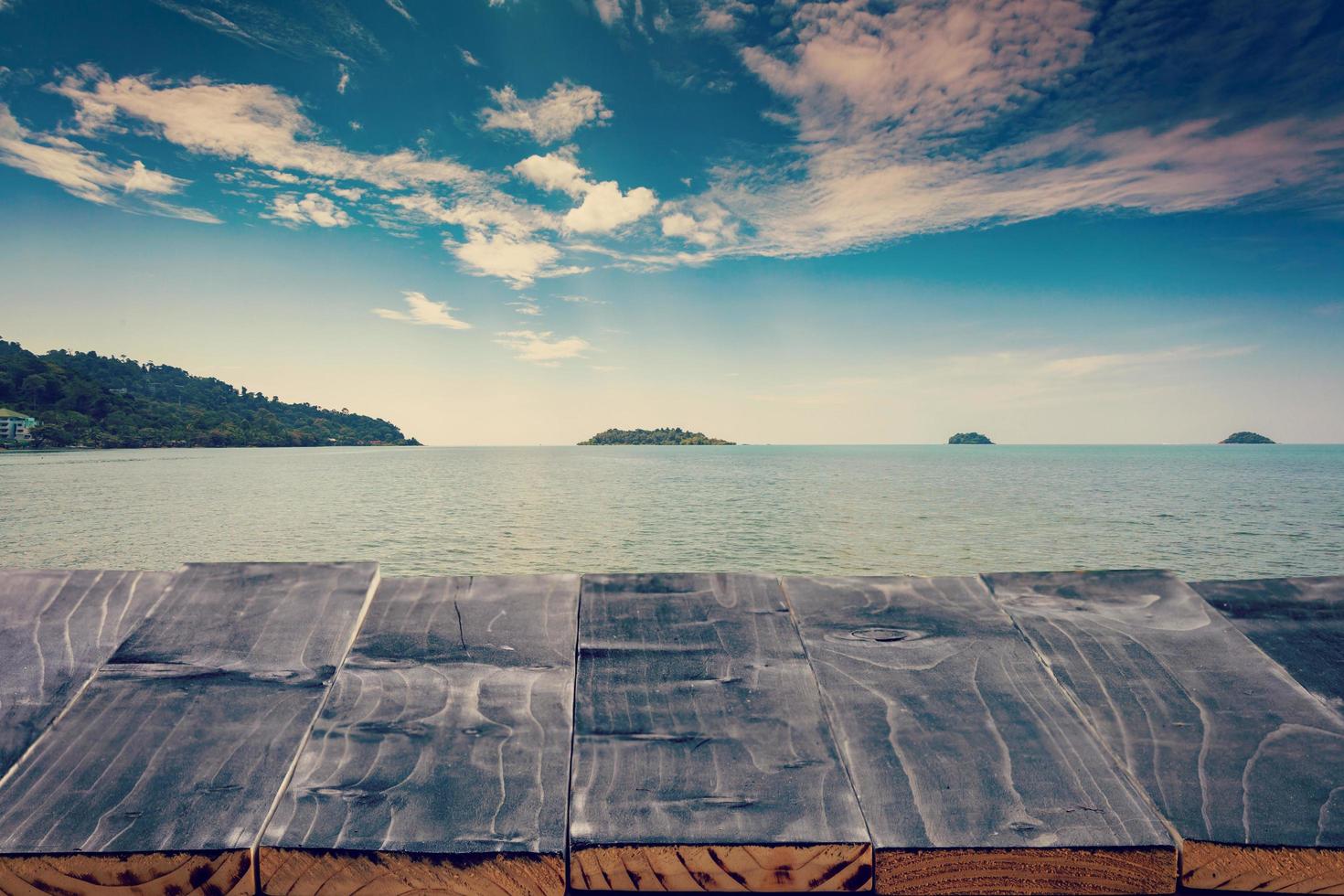 Empty Top of wood table with sea and island. For Product display montage. Beach in summer Concept. photo