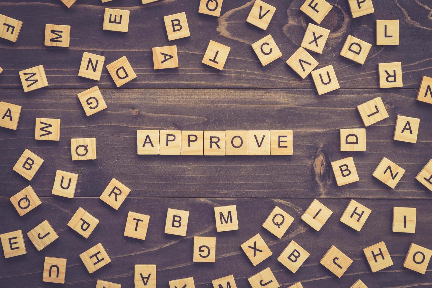 Approve word wood block on table for business concept. photo