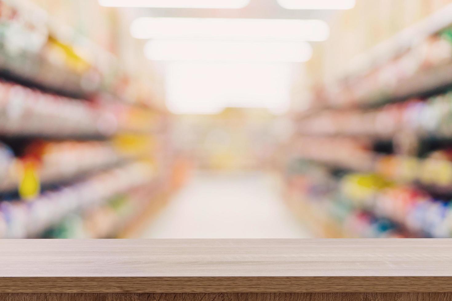 Empty wooden table top with blurred modern shopping mall background for product display and montage. photo