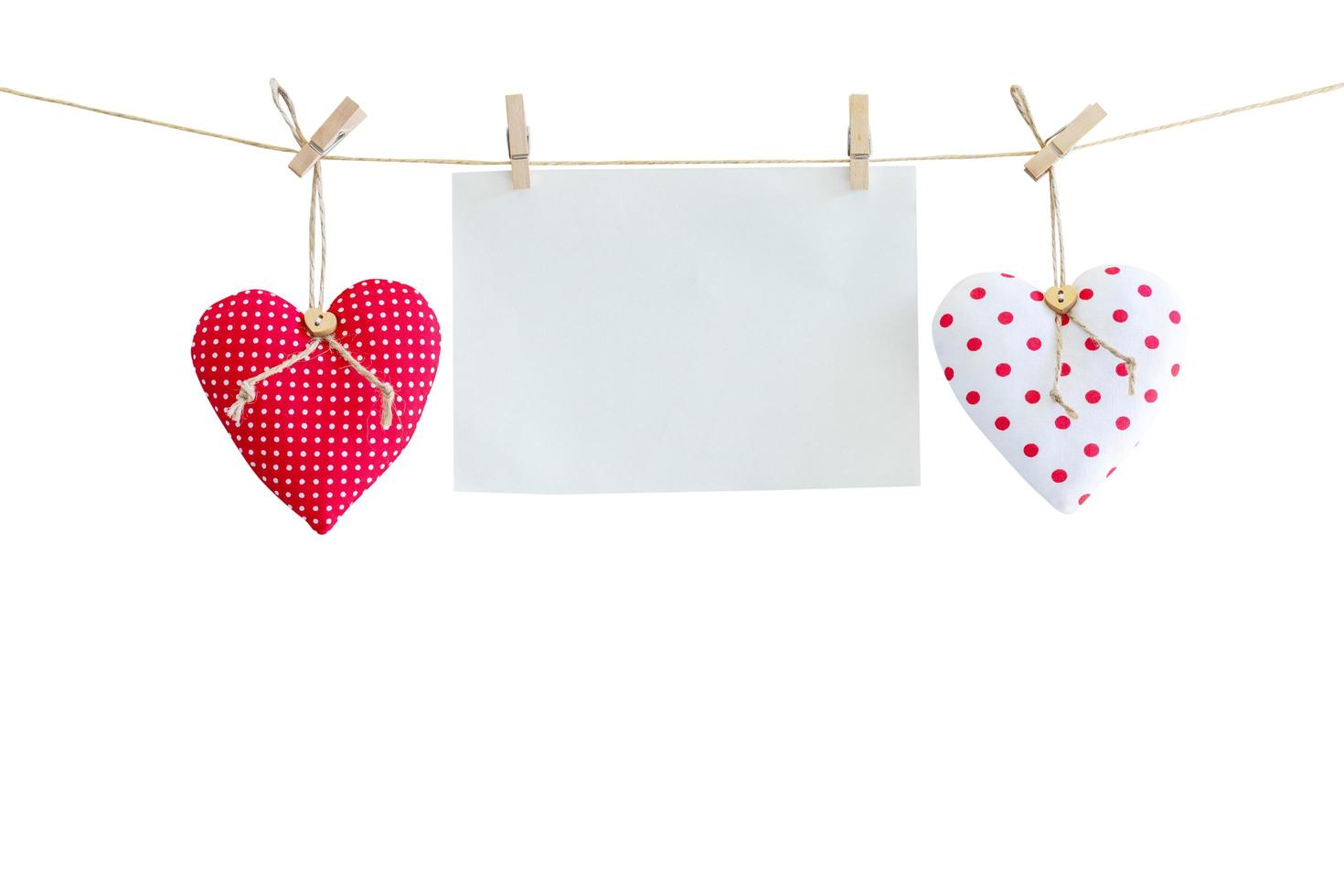 Heart and balnk paper hanging on isolated white with clipping path. photo