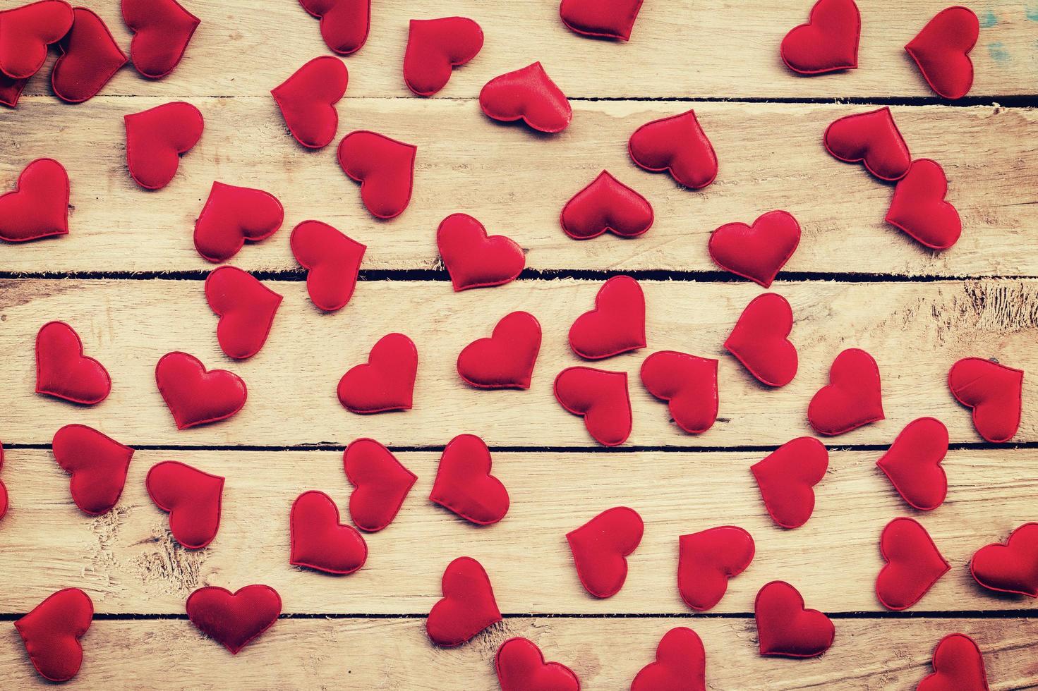 Red heart on wood background with vintage toned. photo