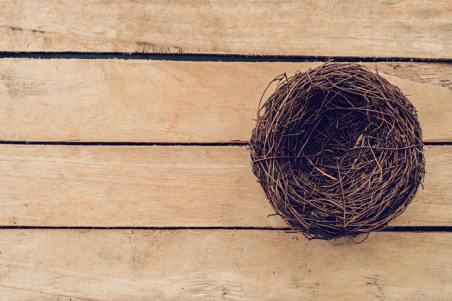 Empty nest on wooden table and background with copy space photo