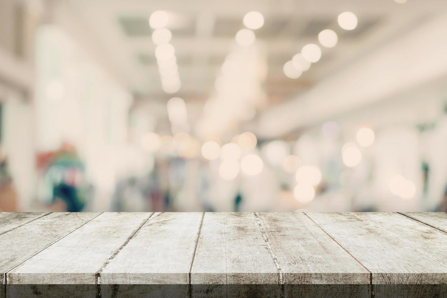 vacío de madera mesa y borroso antecedentes - Tienda de compras centro comercial difuminar antecedentes bokeh con monitor montaje para producto. foto