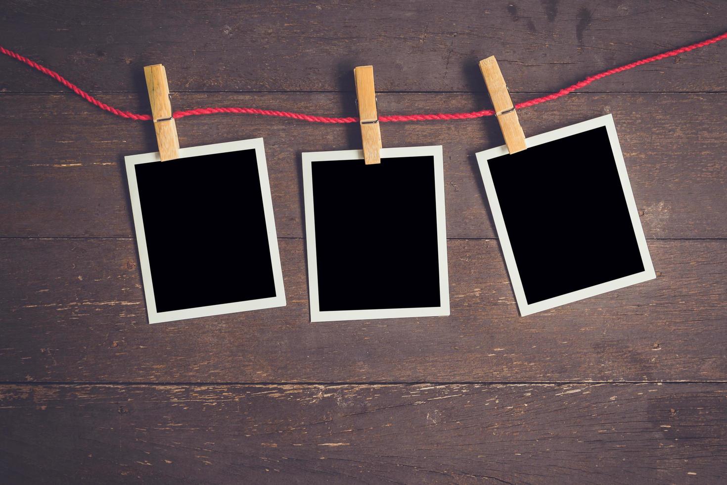 Photo frame hanging on wood table background