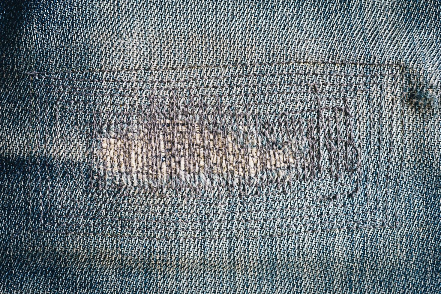 close up patch old jeans denim texture and background. photo