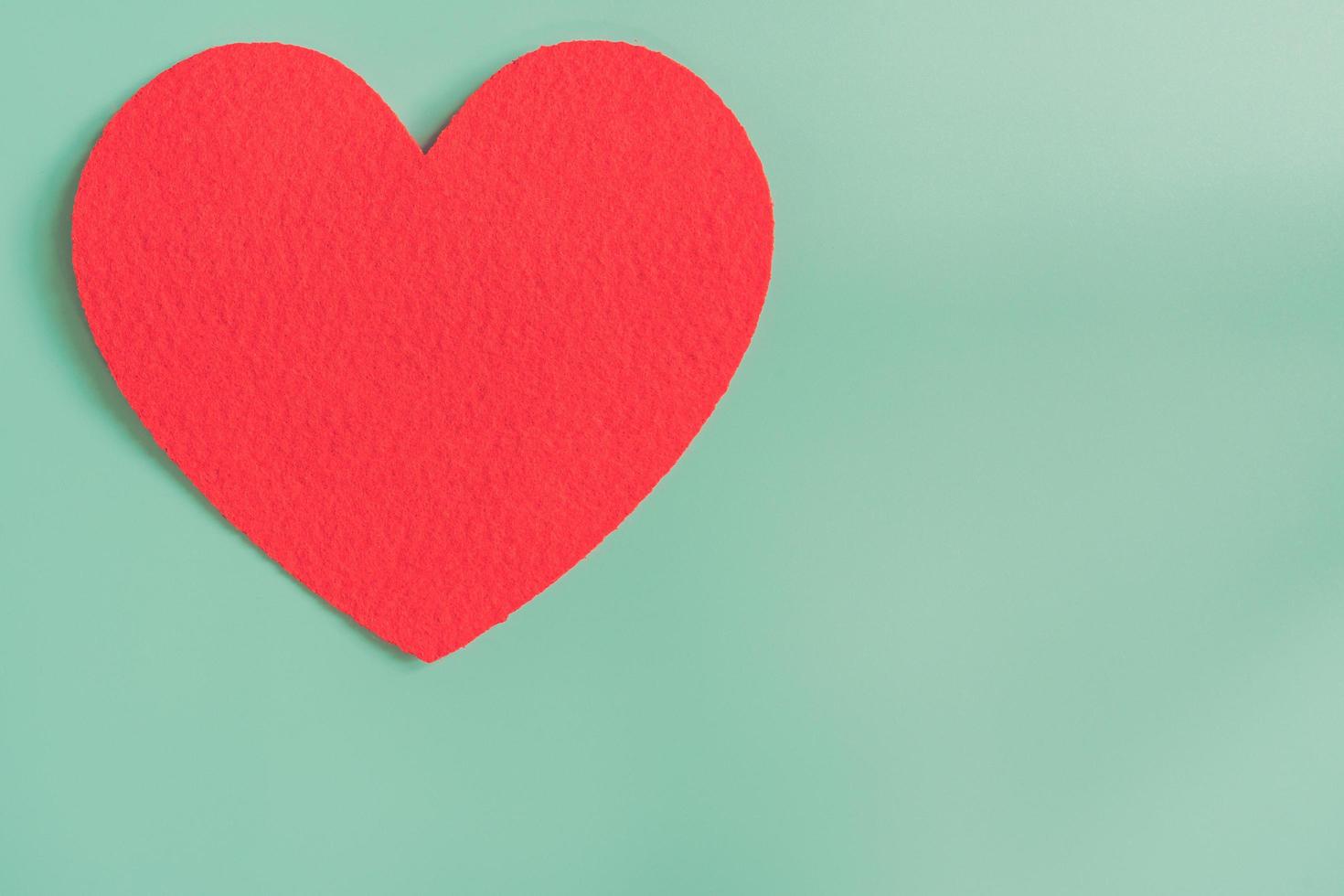 red heart on pastel color background with space. photo