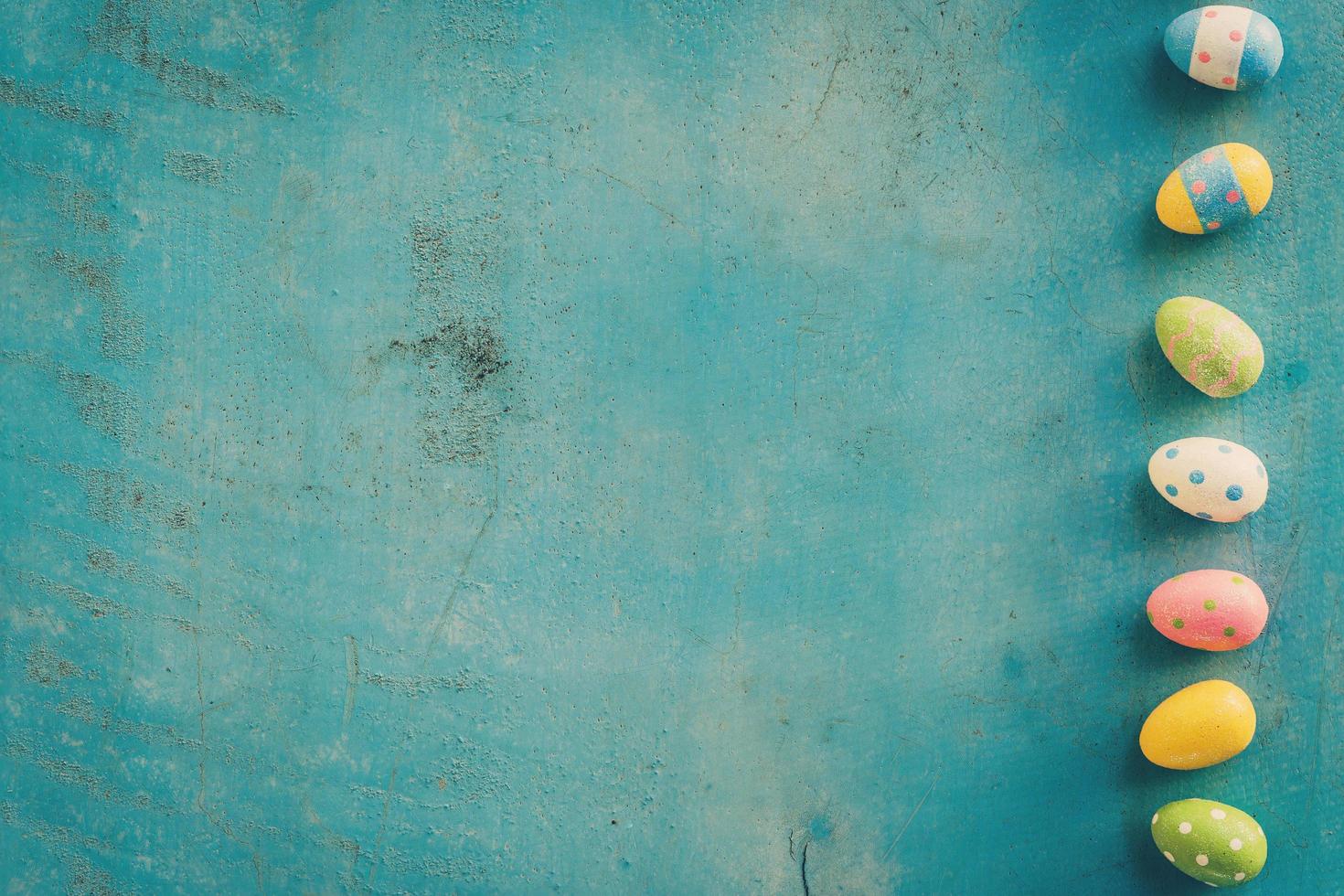 Colorful easter egg on blue pastel color wood background with space. photo
