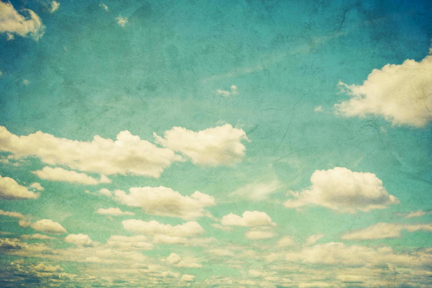 Grunge blue sky and white clouds with vintage effect. photo