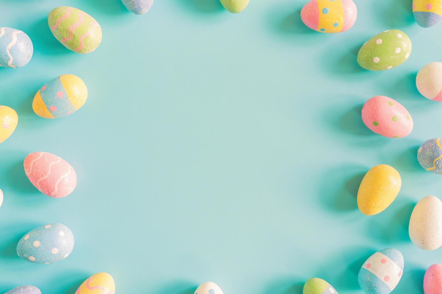 Coloeful easter eggs on pastel color background with space. photo