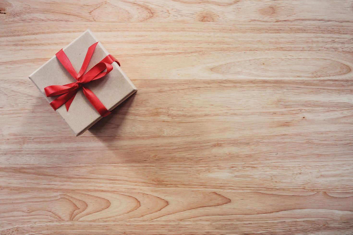 Brown gift box on wooden table background with copy space photo