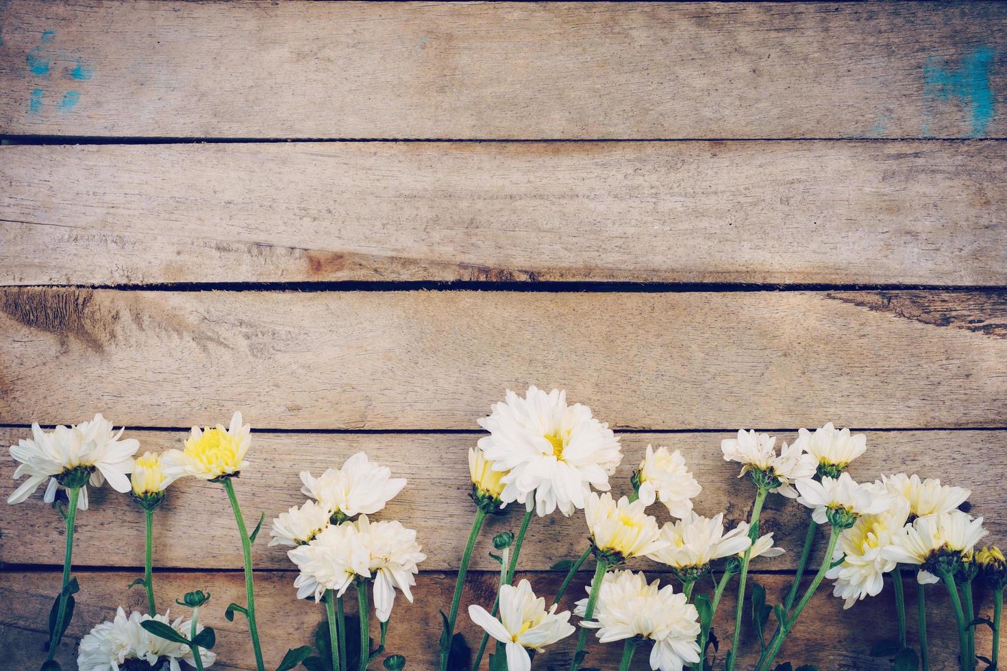 Flowers on old grunge wooden table texture and background with copy space. photo