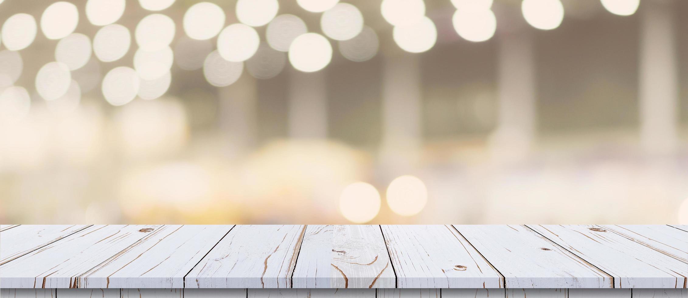 Empty wood table and blurred light table in shopping mall with bokeh background. product display template. photo